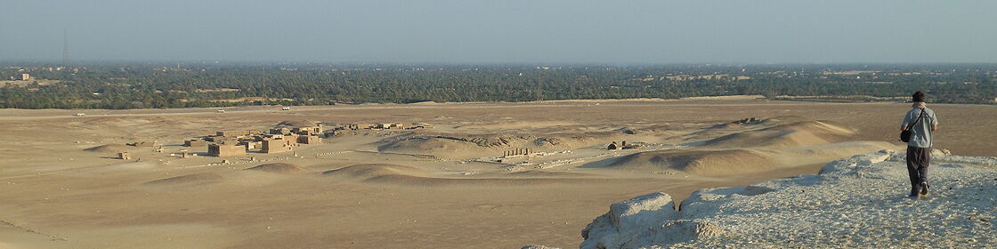 Panoramic view of the archaeological site and surrounding desert landscape, seen from an elevated vantage point.